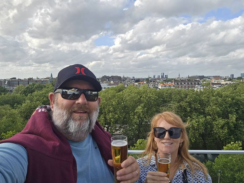 couple holding glasses of beer in amsterdam