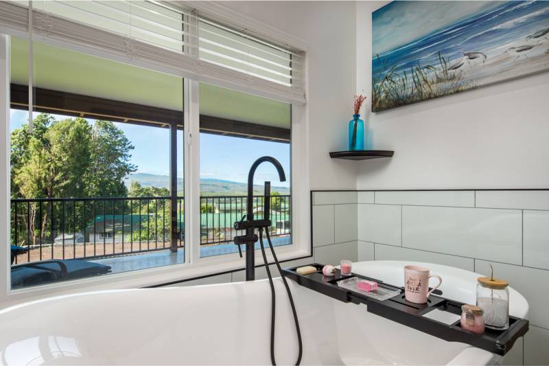 luxurious bathtub with window above it