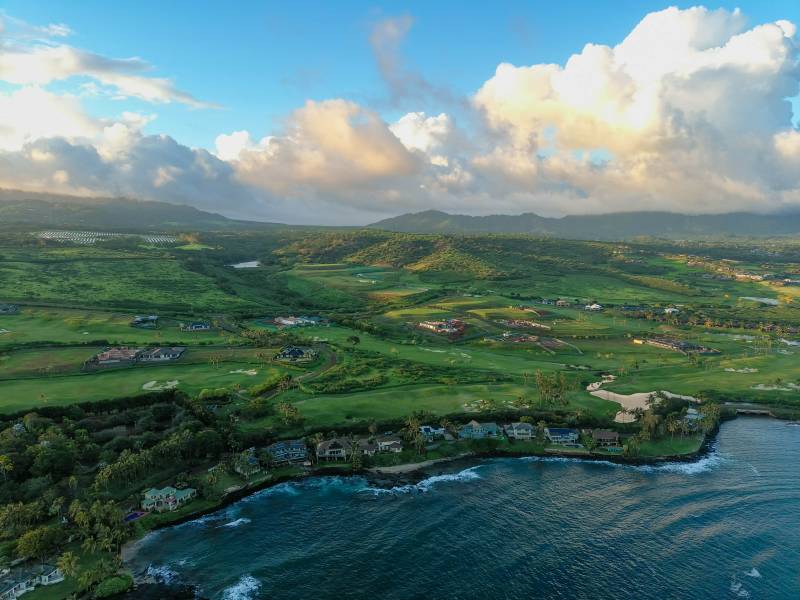 view of kukuiula community with ocean in foreground and mountains in background