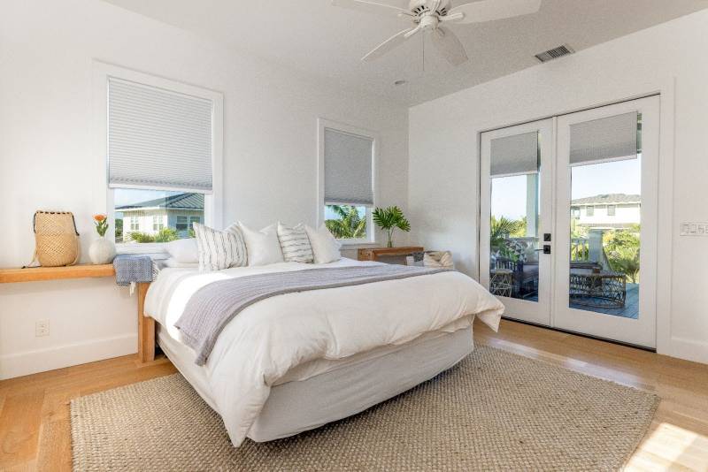 bedroom in poipu beach estates with glass doors to lanai