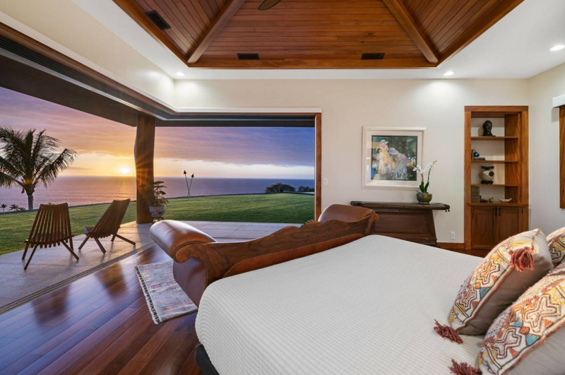 large pocket doors open from bedroom to patio with sunset view