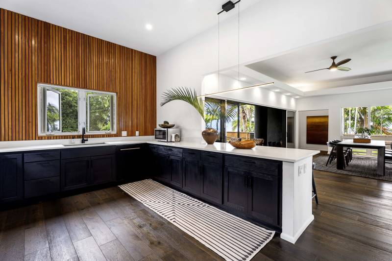 black cabinets and warm wood walls in kitchen