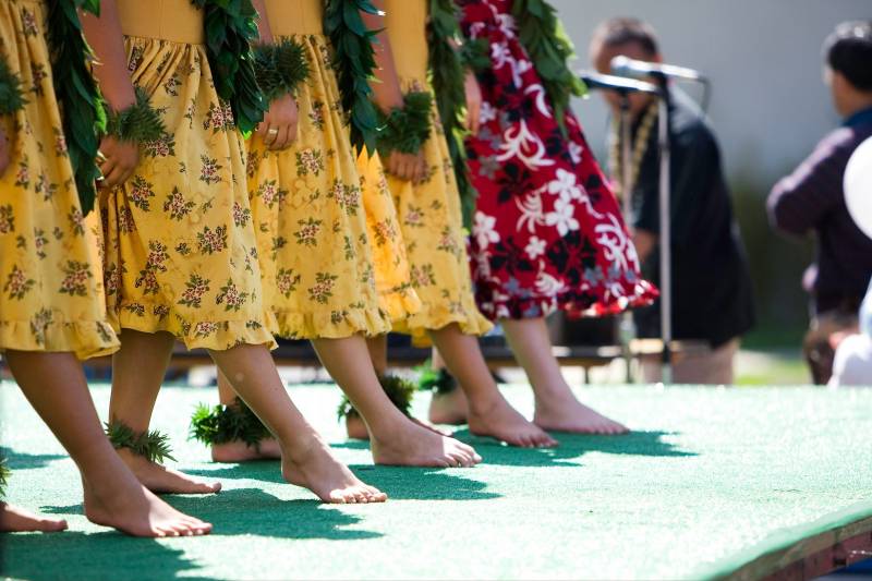 feet of hula dancers on stage