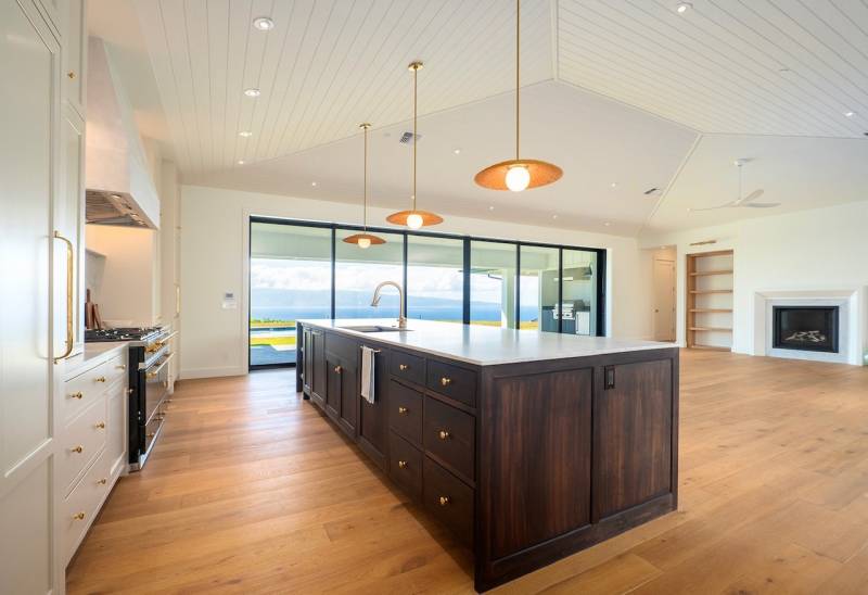 large open kitchen with large sliding glass doors to let in ocean views