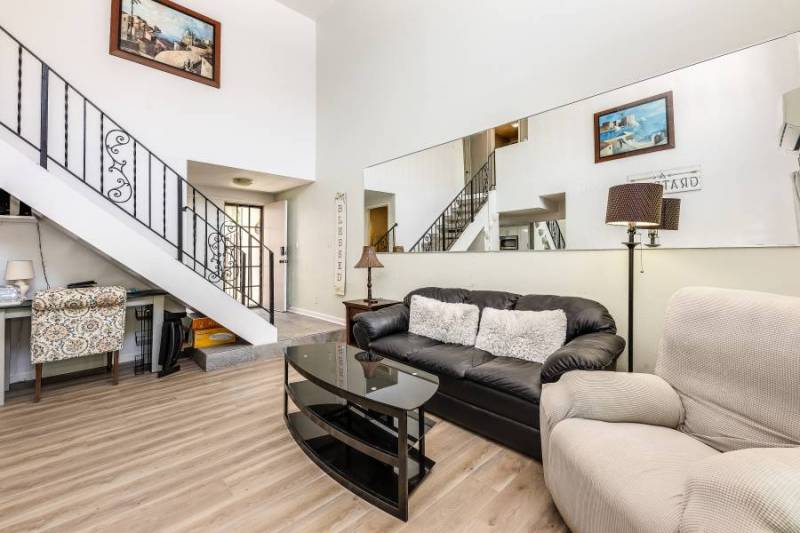 living room with stairs leading up to second level