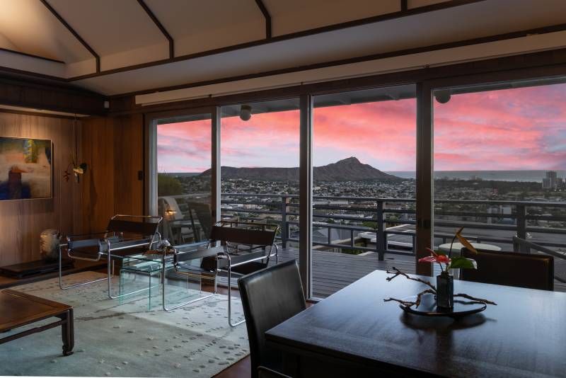 sunset view through large windows in luxury home on oahu