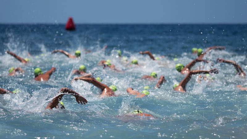 swimmers in ocean in ironman competition 