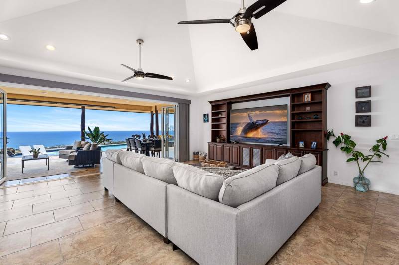 living room space with large sliding doors and ocean view