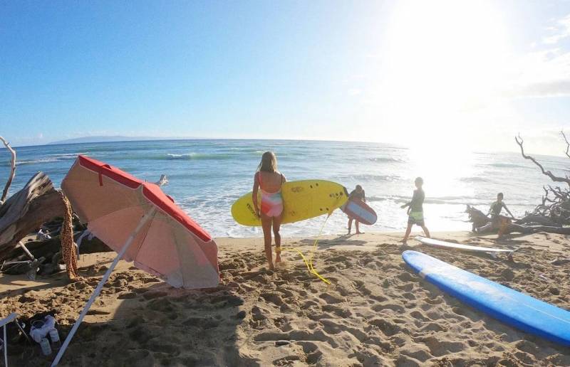 surfers at the beach on maui