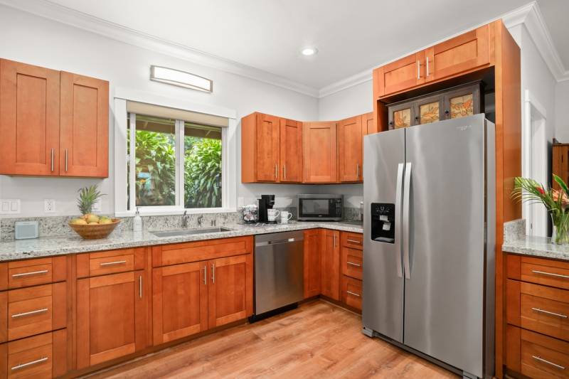 warm wood cabinets with granite countertops in kauai condo for sale