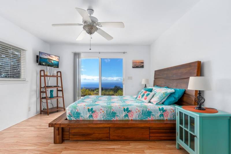 bedroom with hawaii ocean view through sliding glass doors