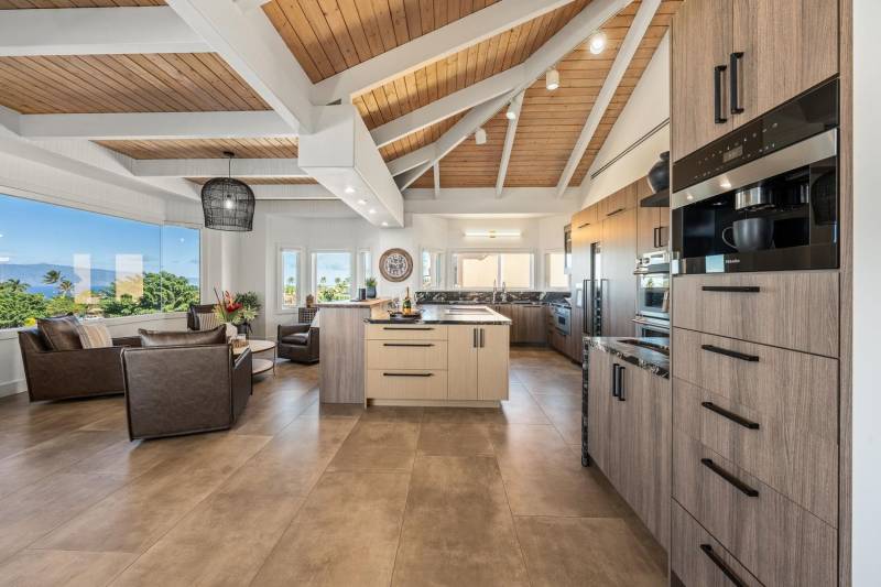 large kitchen and comfortable seating area with ocean views out the large windows