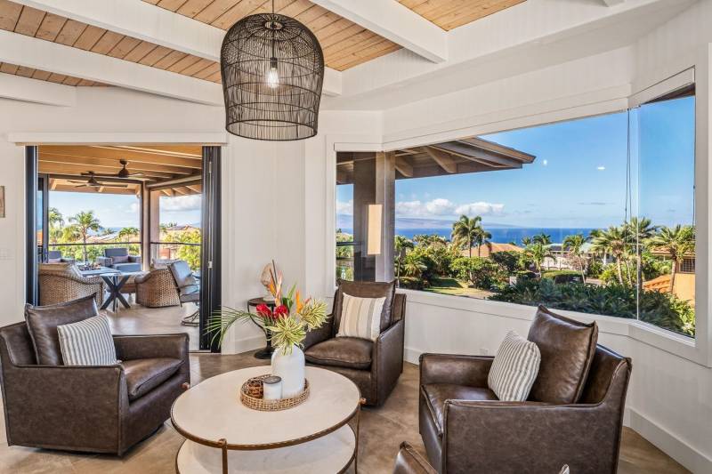 panoramic views of maui ocean through large windows in sitting room