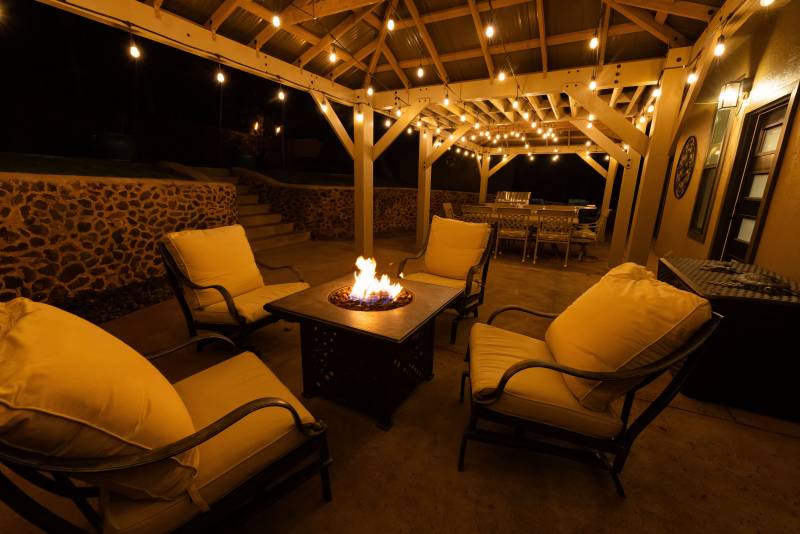 ourdoor seating area under pergola with lights