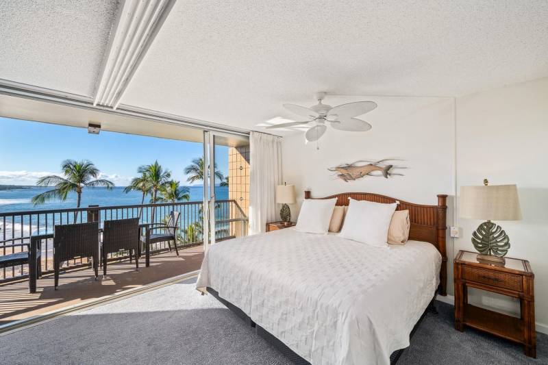 bedroom with doors to lanai and ocean views on maui