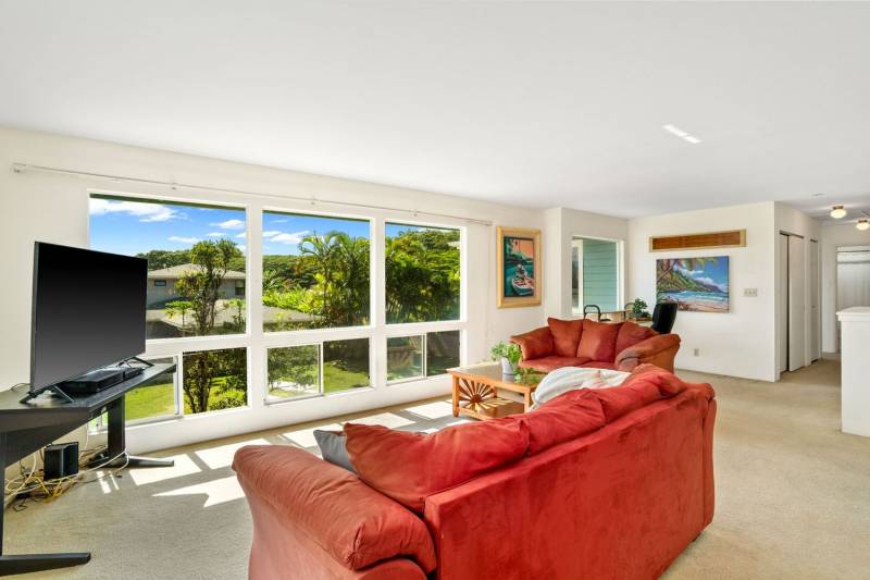 living space with large windows overlooking grassy yard