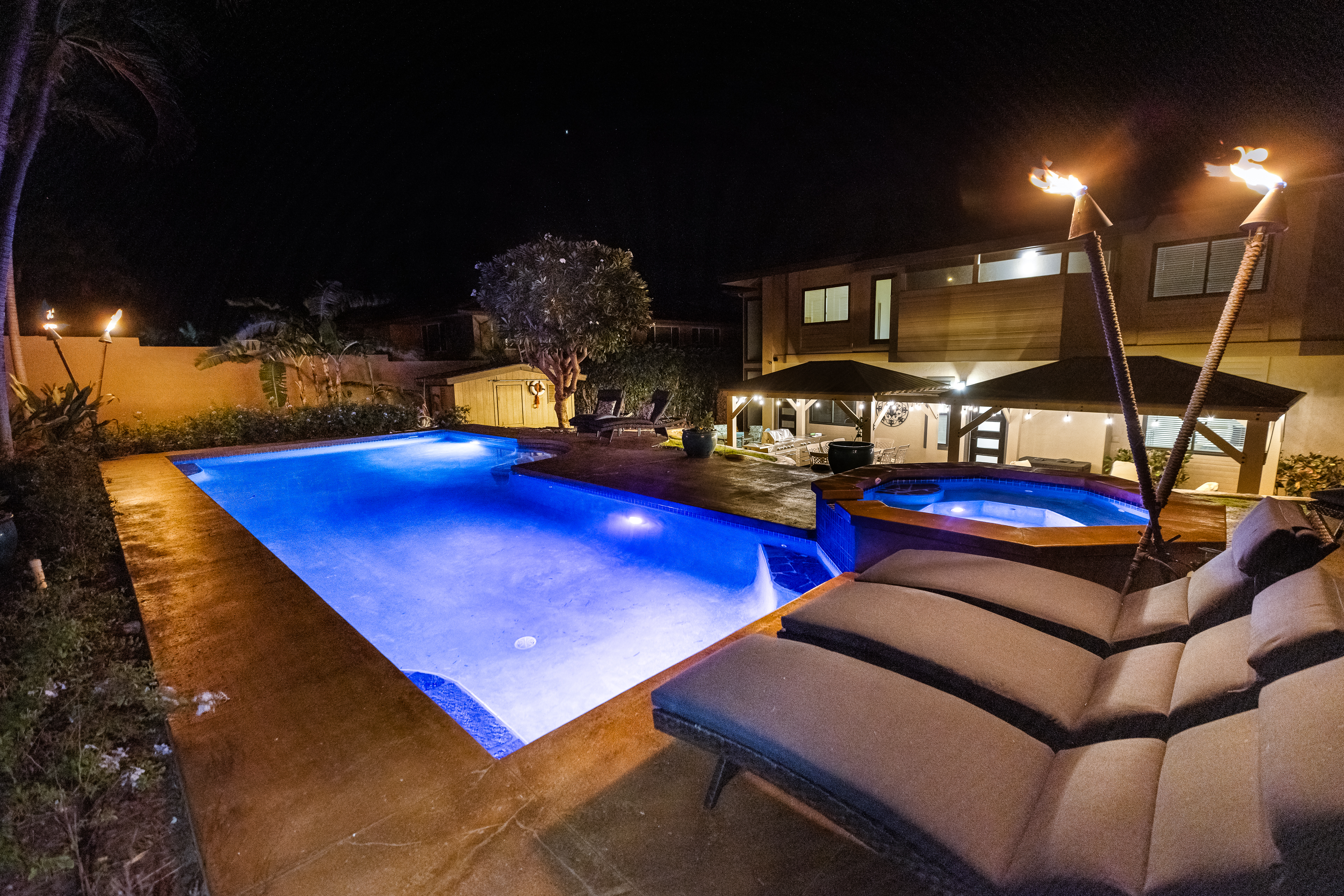 pool and jacuzzi lit up at night