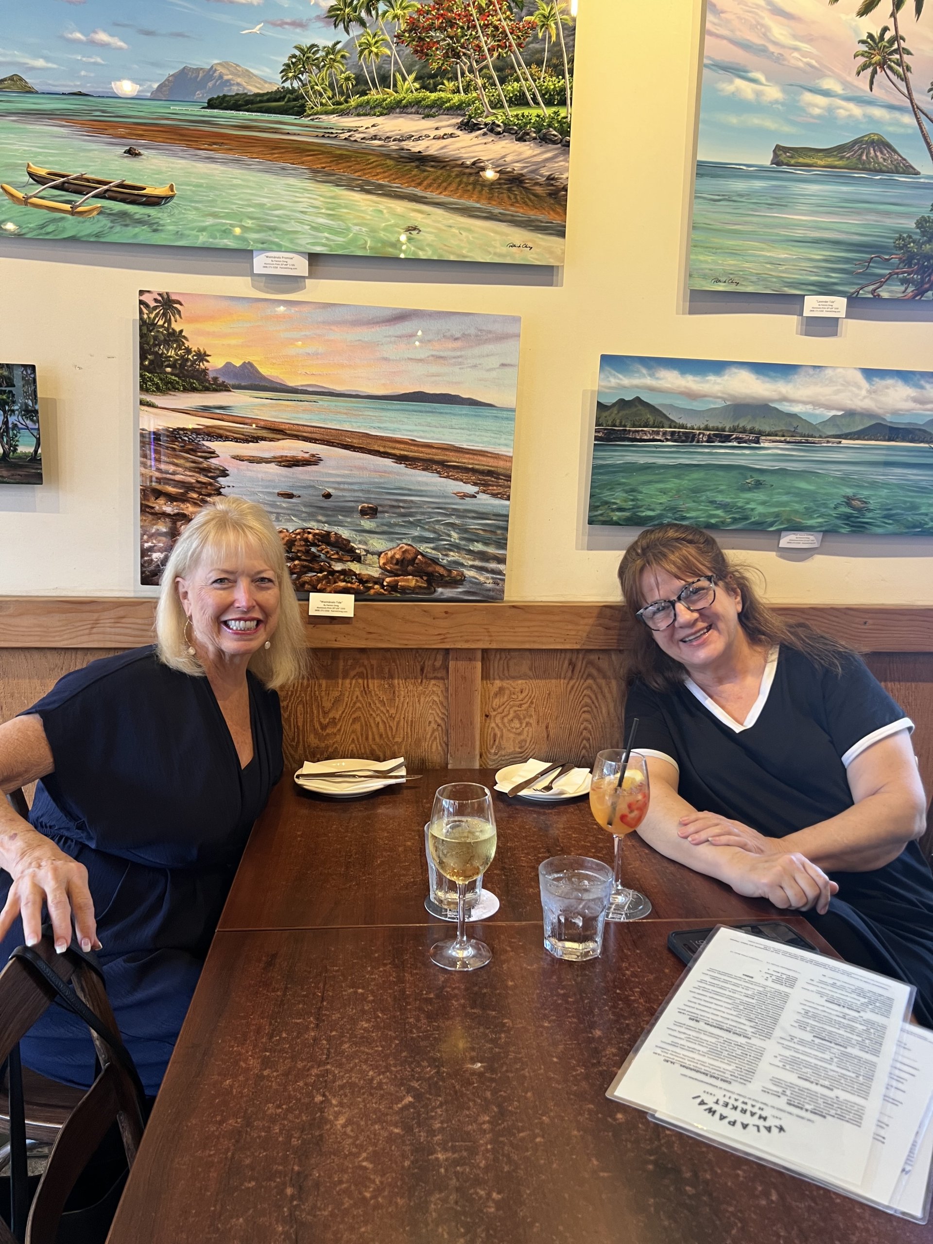 two women seated at table at kalapawai market cafe