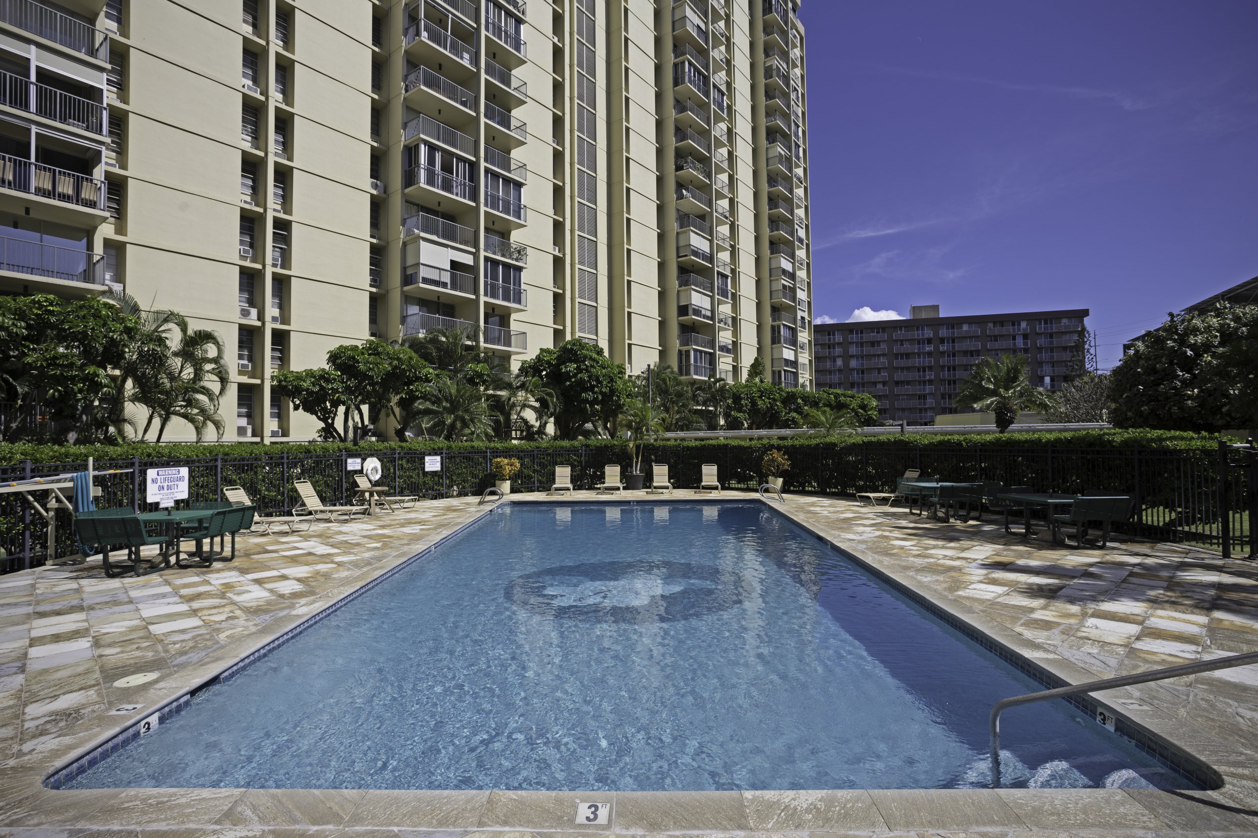 Large swimming pool and landscaped common area at Century West condominium community
