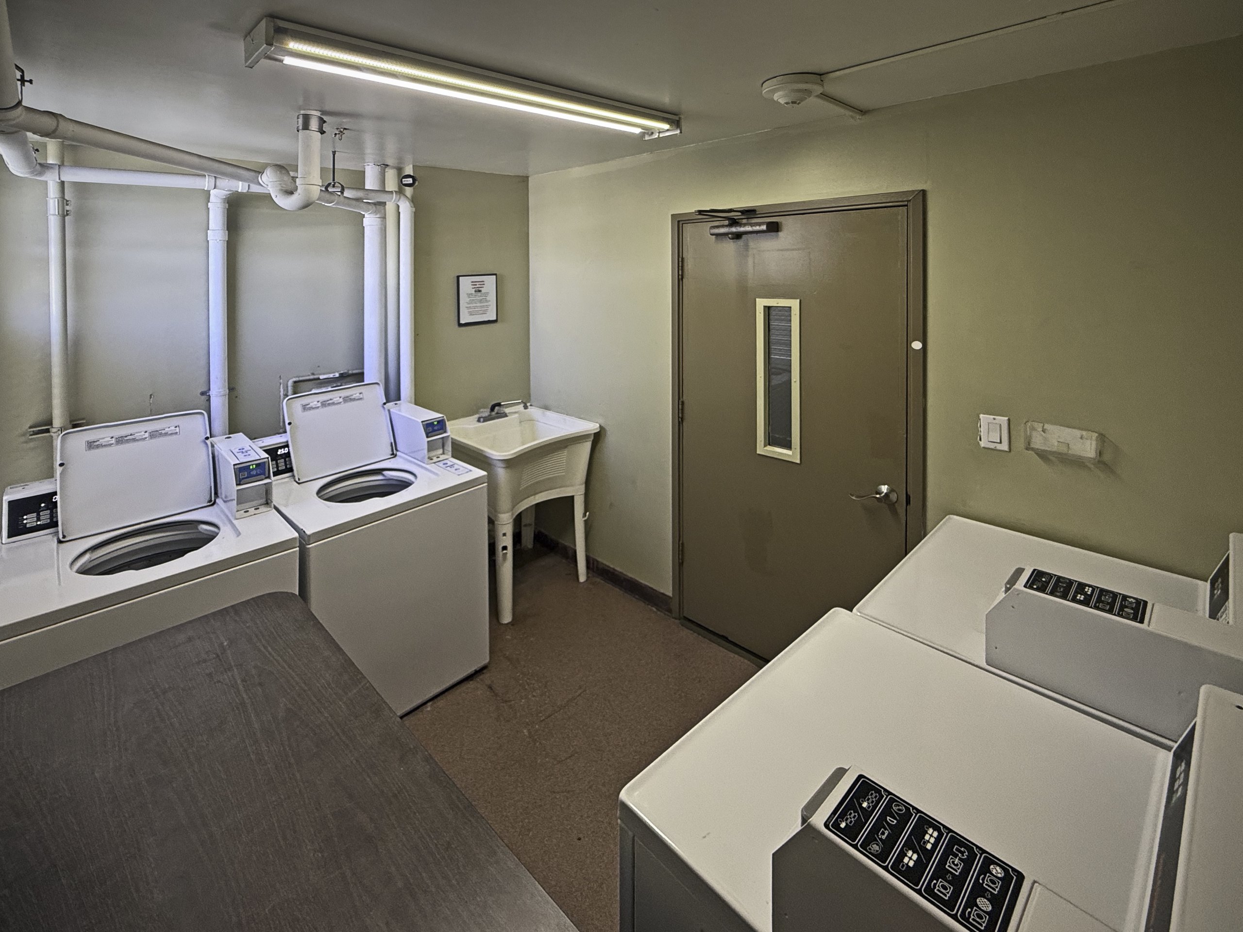 Communal laundry room in Century West condo building in Oahu