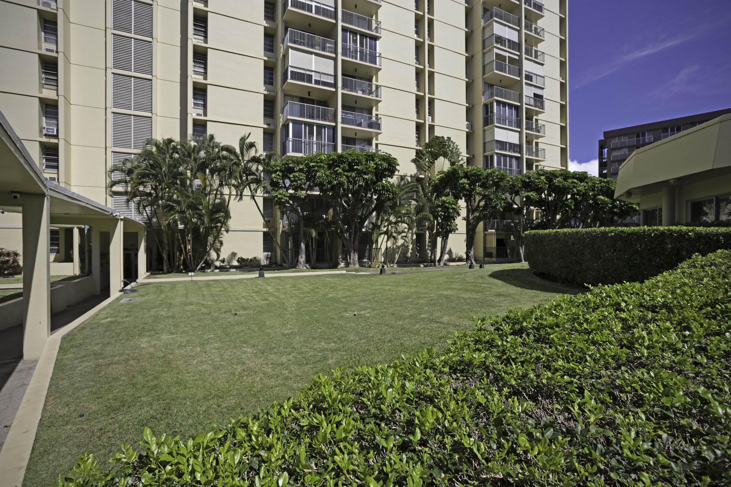 Century West condominium building in Salt Lake, Honolulu, a concrete high-rise with landscaped grounds