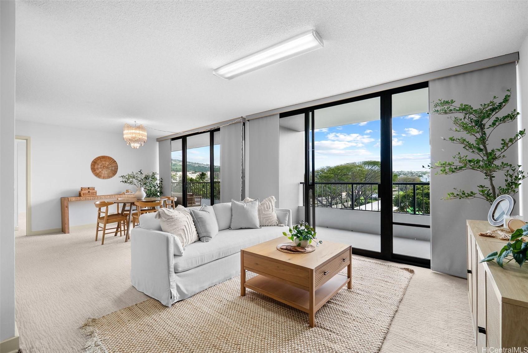 Bright and spacious living and dining room with two sliding doors to lanai