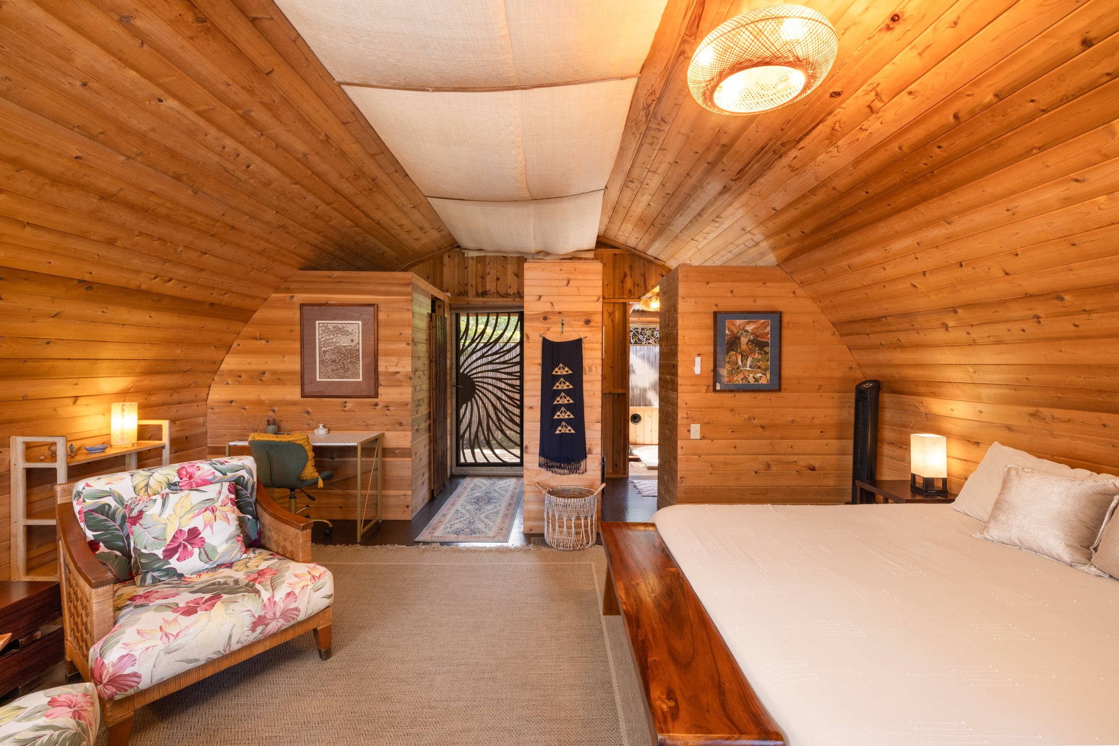 Bedroom with cabin style cedar wood walls and ceiling