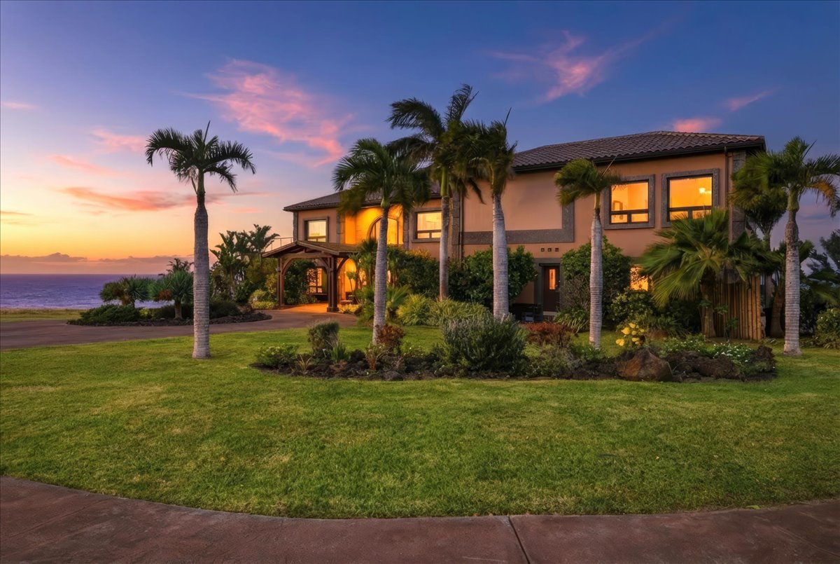 Two-story estate with wraparound lanais overlooking the coastline