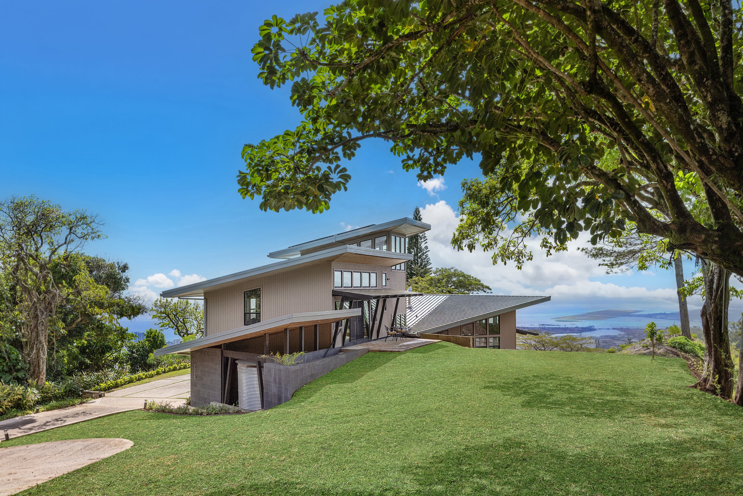 Three-story residence stepping down a steep ridge with ocean views