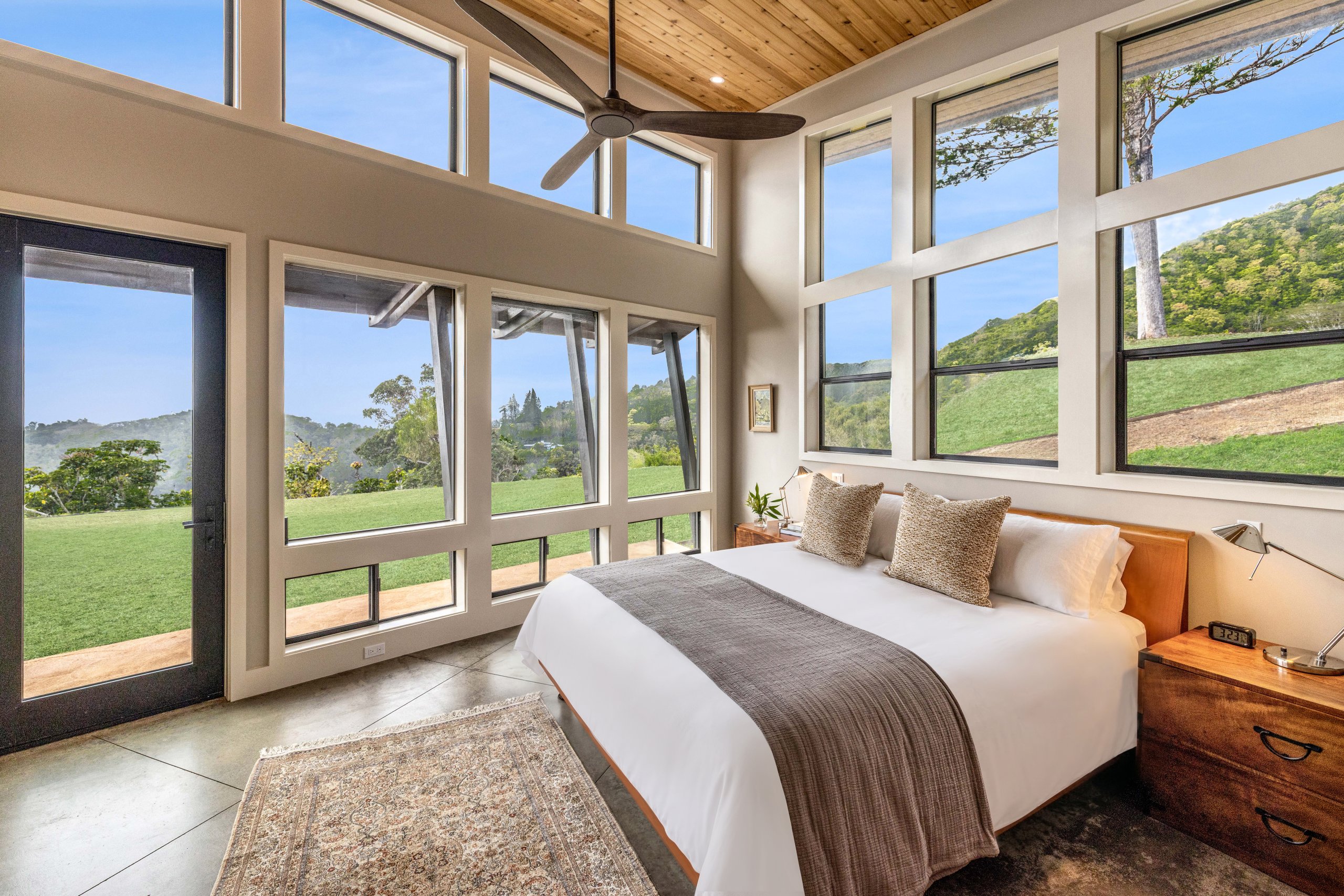 Bedroom on ground floor with lots of windows to let in surroundings in Hawaii