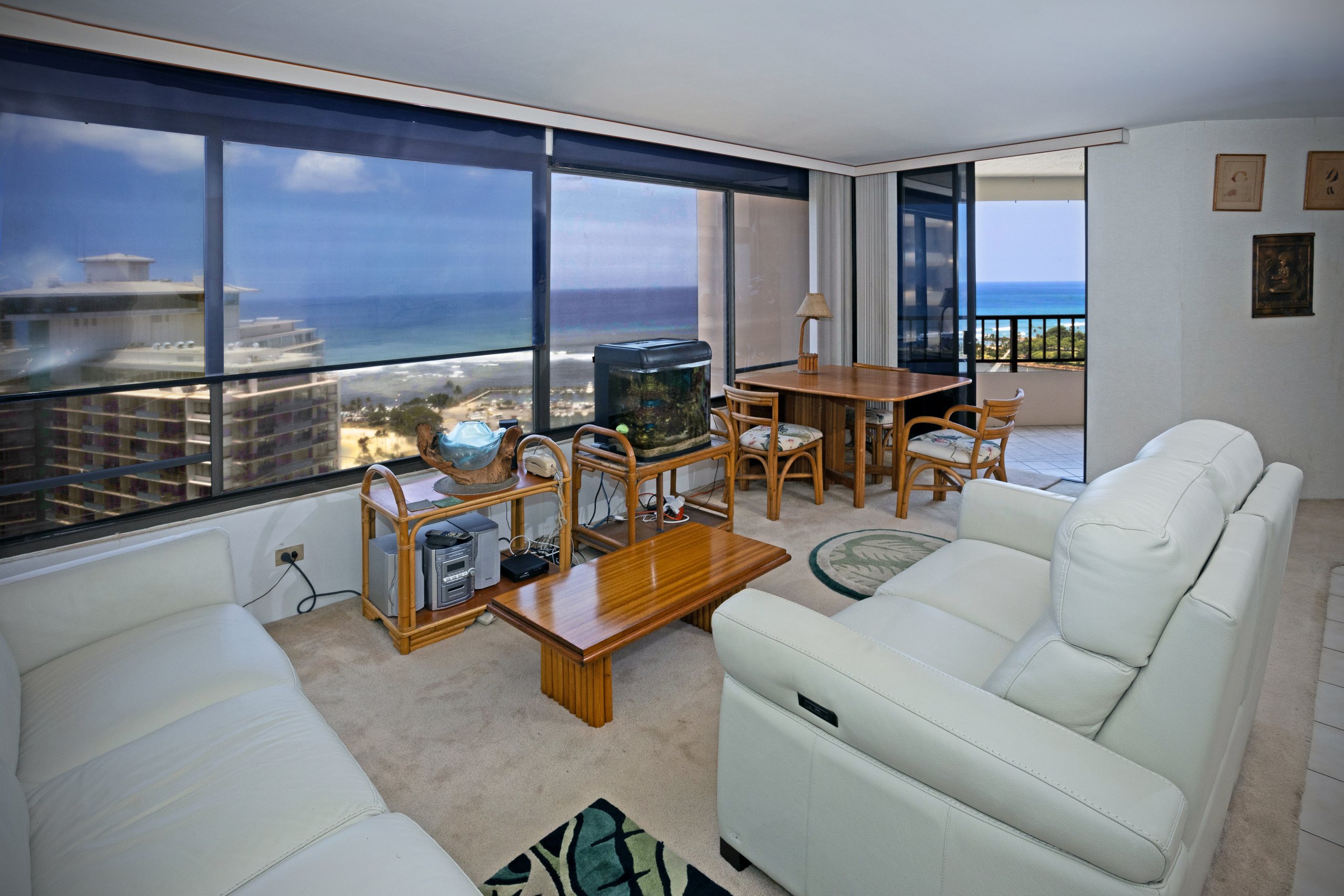 Living room with large windows and ocean views at Discovery Bay #3401