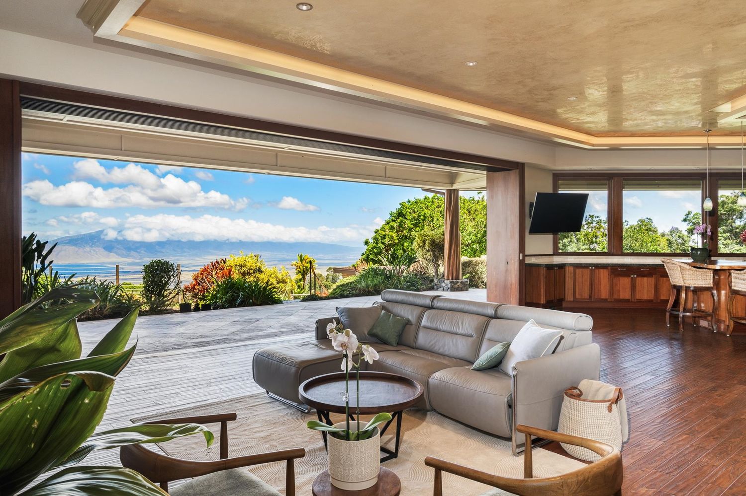 Spacious great room featuring 11-foot ceilings and pocket sliding doors opening to outdoor living areas