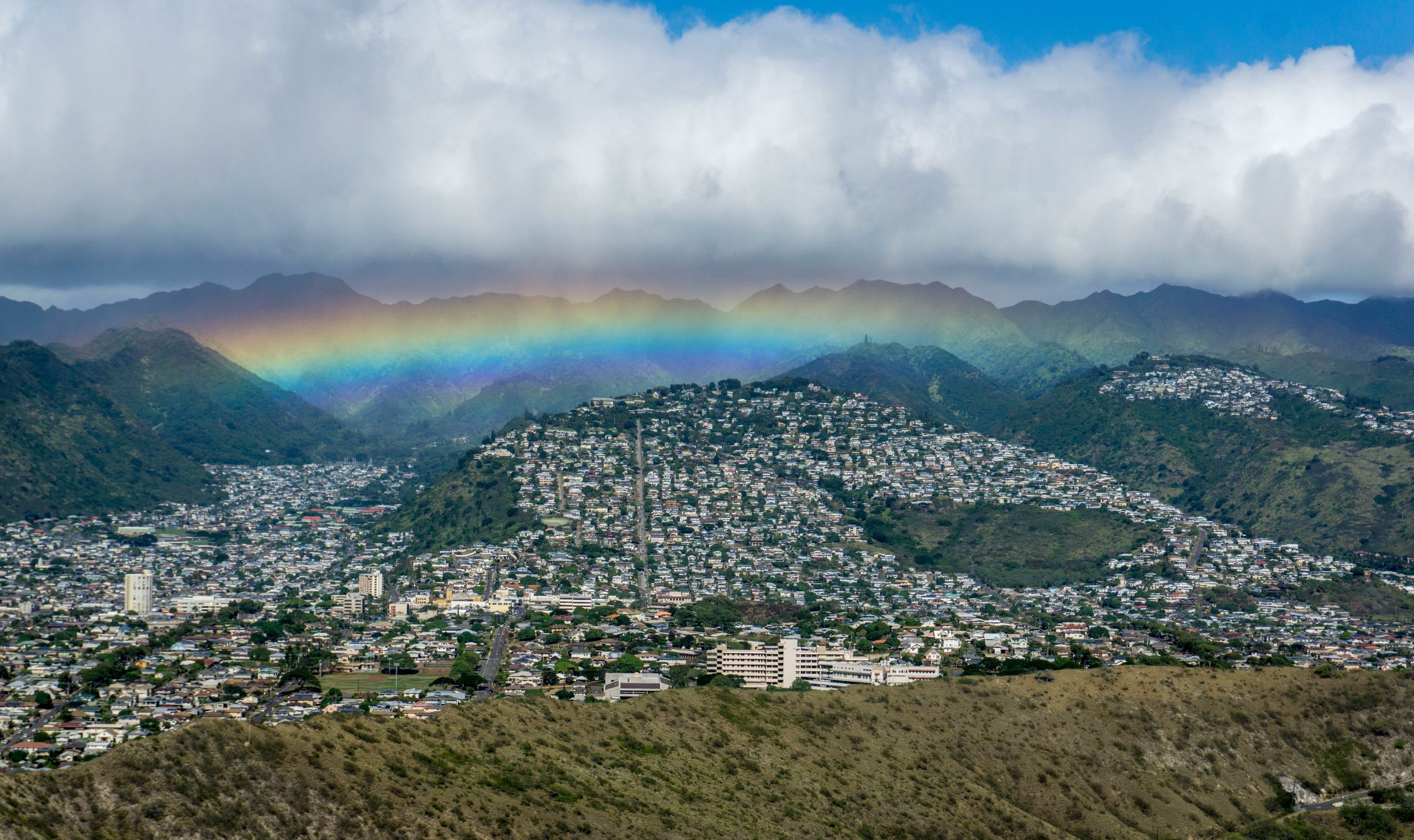 Aerial view of rainbow after rain storm in Honolulu Oahu