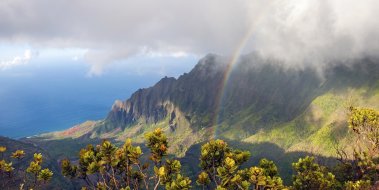 Rainbow over the Kalalau Valley cliffs and ocean from Kōkeʻe, Kauaʻi, retiring to Kauaʻi