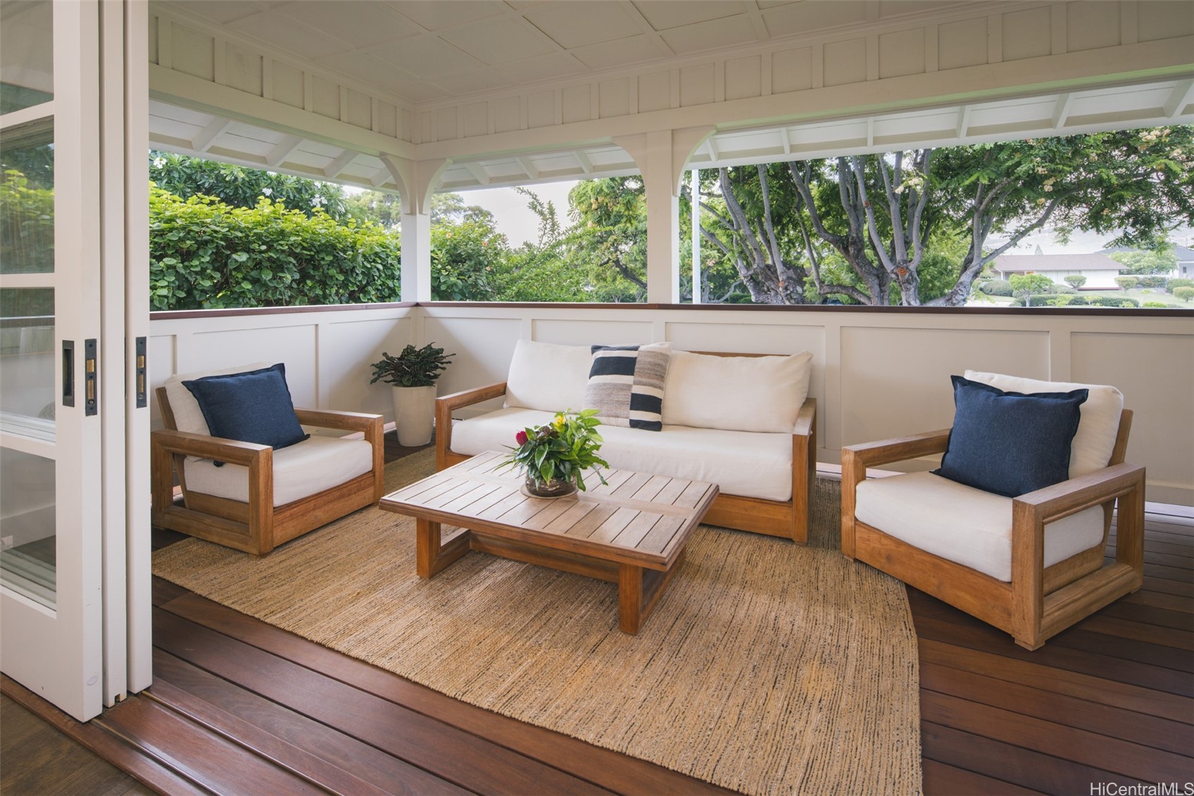 Covered lanai with seating with sliding pocket doors to let the outside in